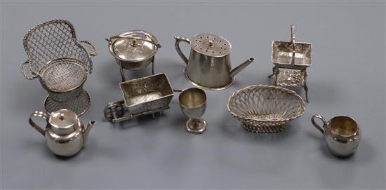 A group of novelty miniature silver and white metal items, including a basket on stand with pseudo Hanau marks,